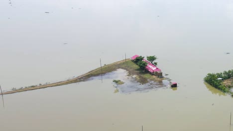 a school house submerged in flood water in bangladesh, aerial shot