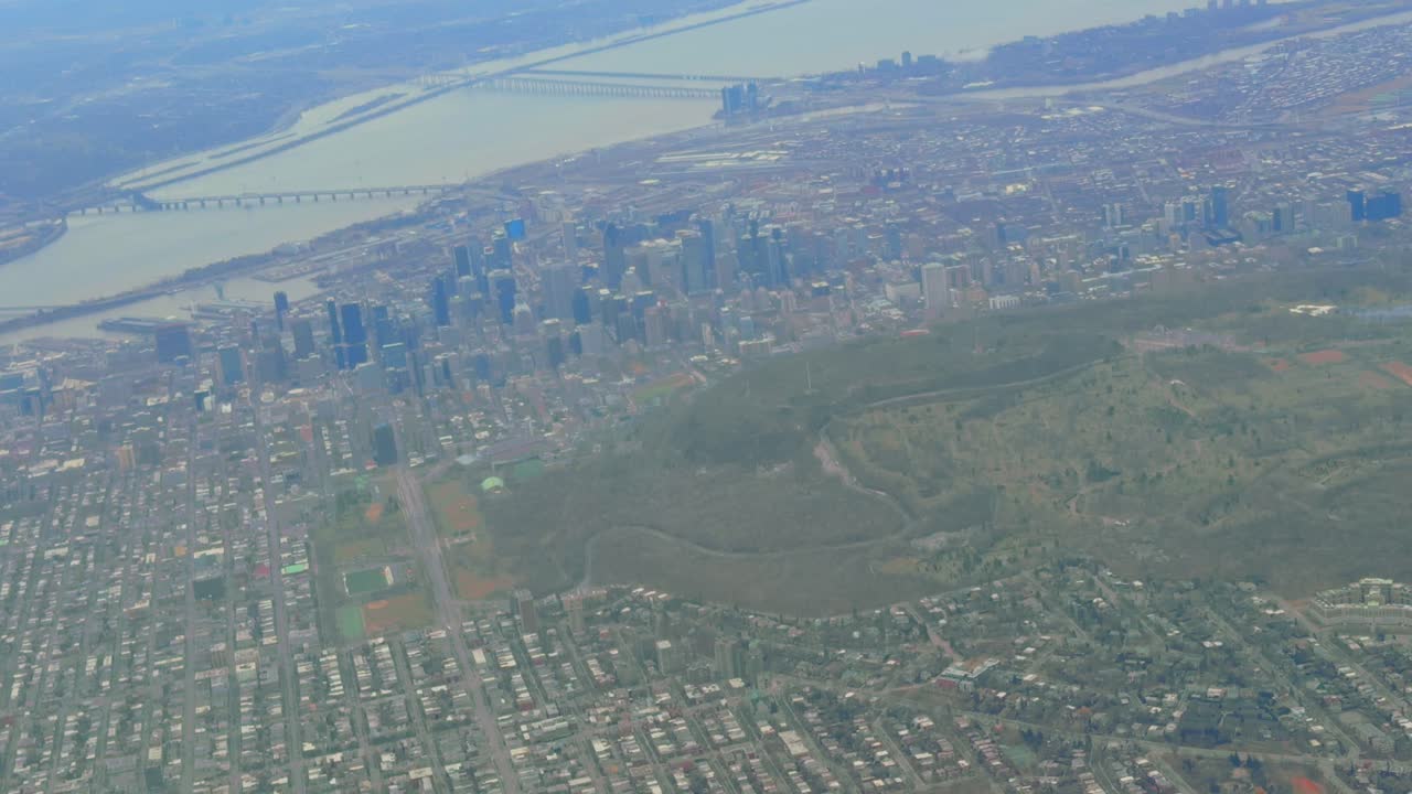 Aerial fly over Mont-Royal and Montreal downtown