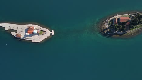 ascending top-down view of our lady of the rocks and gospa od skrpjela islets off the coast of perast in the bay of kotor, montenegro