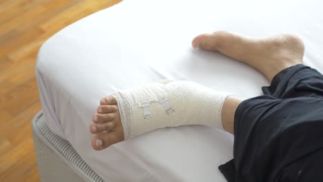 Woman-with-bandaged-foot-close-up-,