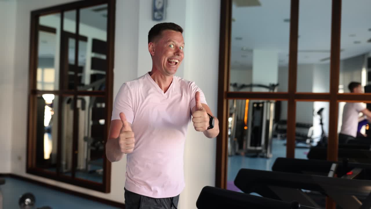 Man giving thumbs up in a gym