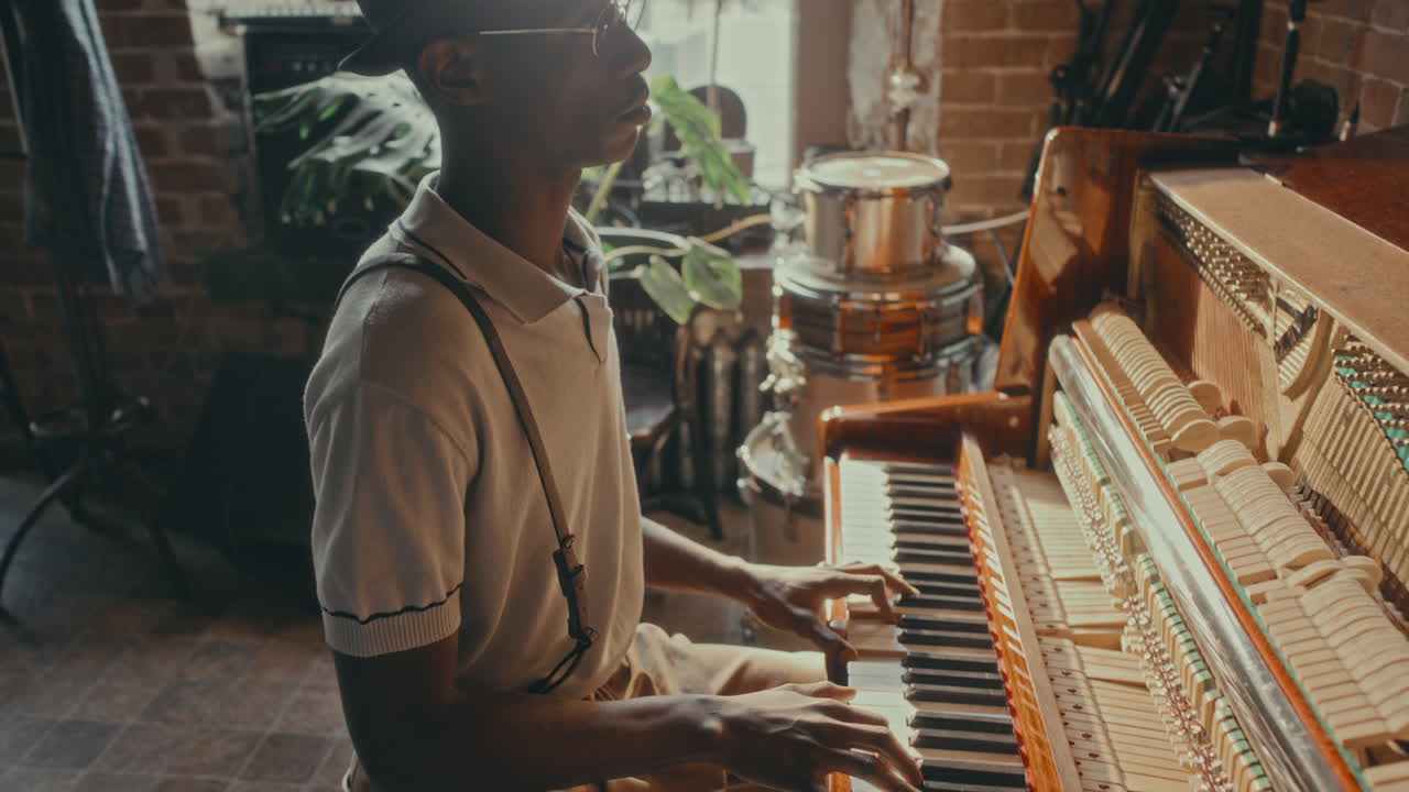 Man playing piano in a vintage style music room