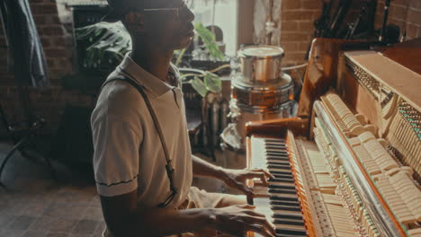 man playing piano in a vintage style music room