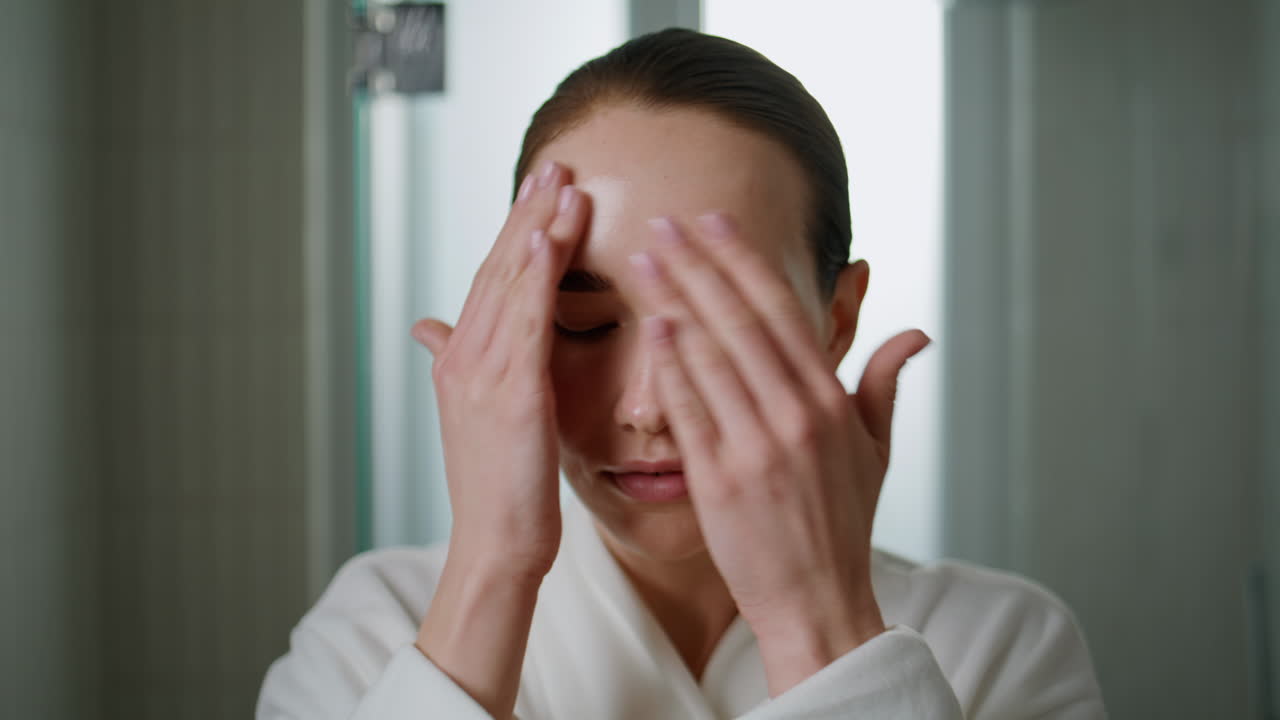 Beauty girl massaging serum on face closeup. Attractive woman applying cream