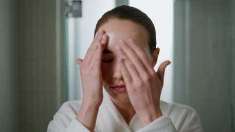 Beauty girl massaging serum on face closeup. Attractive woman applying cream