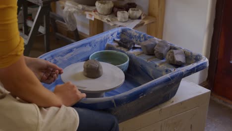 young female potter working in her studio