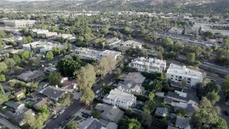 Push-forward-aerial,-over-houses-in-Van-Nuys-community-during-day