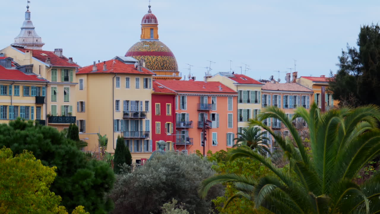 Colourful buildings and trees in the skyline of Nice, France on a cloudy day