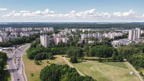 aerial view of modern housing complex in suburbia of kaunas, lithuania, condo buildings, streets and parks in summer season, drone shot