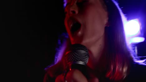 female singer singing into a microphone 4k