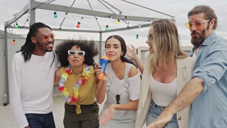 Group of friends having fun at a rooftop party