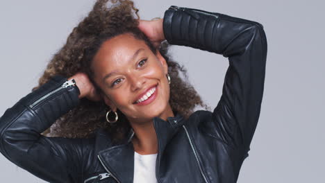 Waist-Up-Studio-Shot-Of-Young-Woman-Wearing-Leather-Jacket-Dancing-In-Slow-Motion