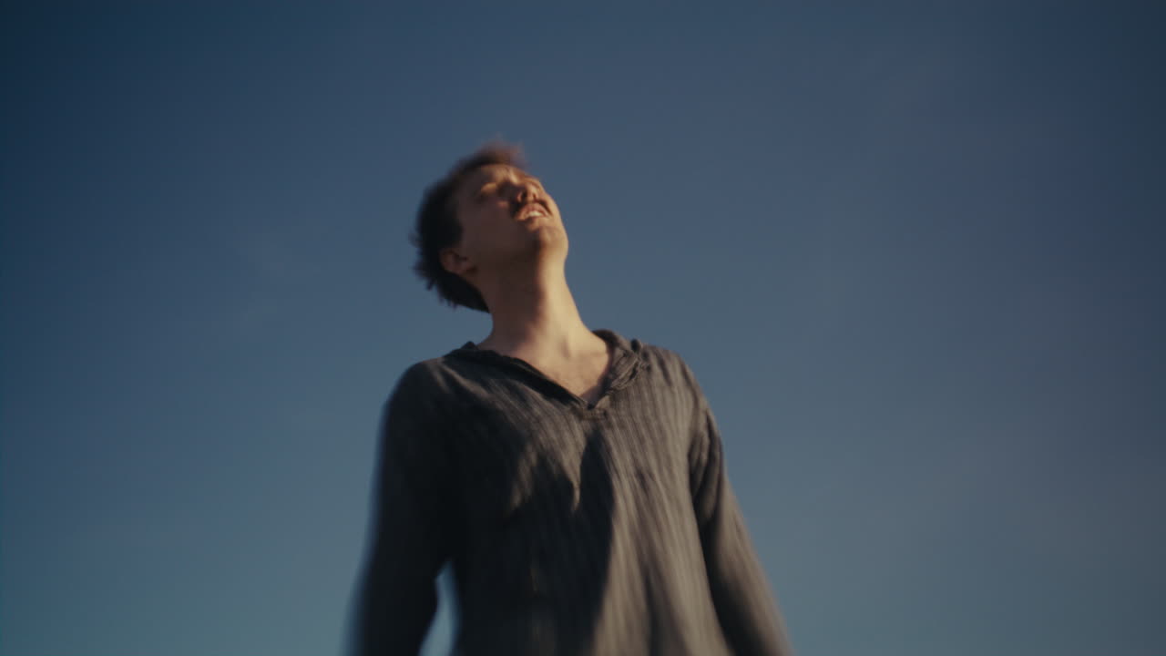 Man Looking Up at Blue Sky