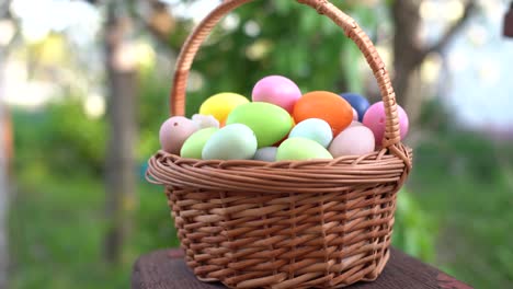 painted-Easter-eggs-in-basket-on-grass.-Traditional-decoration-in-sun-light