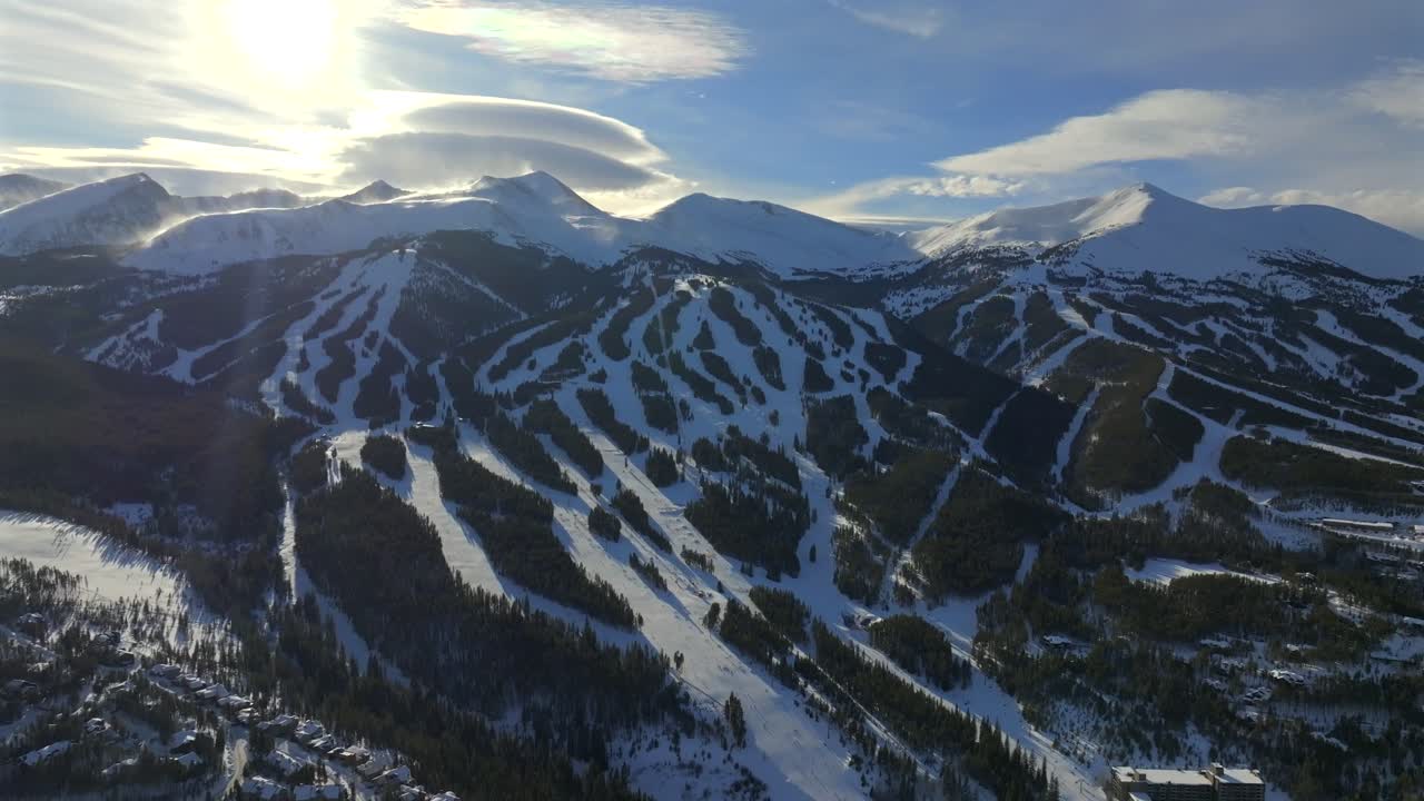December Breckenridge Ski Resort mountain town Colorado aerial drone sunset Winter December January skiing trails run Peak 9 10 Ten Mile Range Bald Mountain Epic Vail Pass cirrus clouds forward pan up