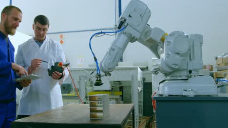 robotic engineers testing robotic machine in warehouse 4k