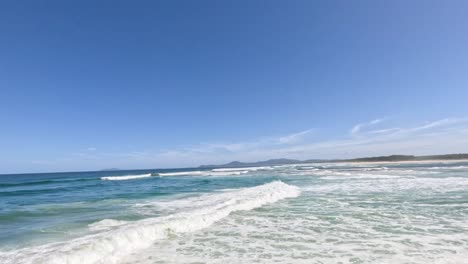 ocean waves under clear blue sky