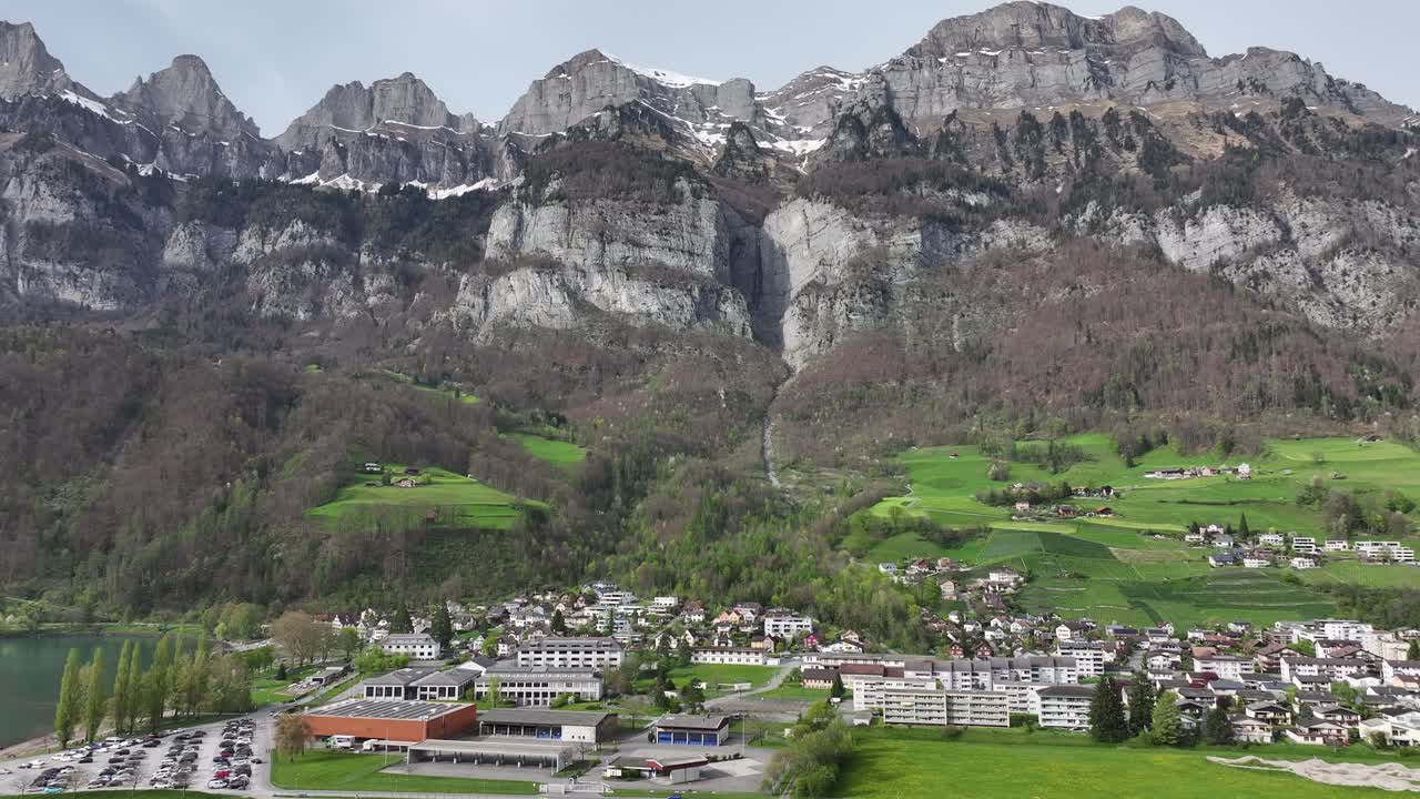 Churfirsten range towering over Walenstadt and Walensee, Swiss idyll - aerial