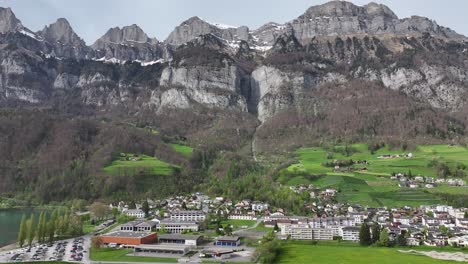 Churfirsten-range-towering-over-Walenstadt-and-Walensee,-Swiss-idyll---aerial