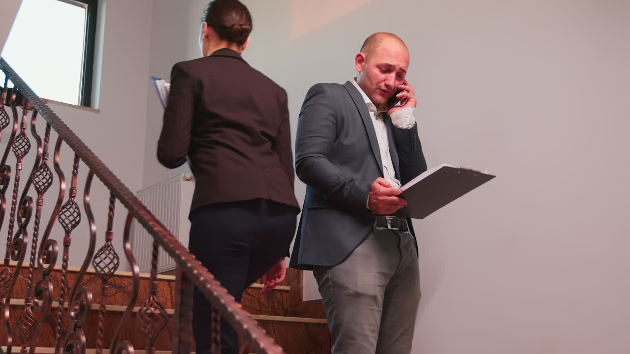 un hombre de negocios furioso hablando en su teléfono inteligente.