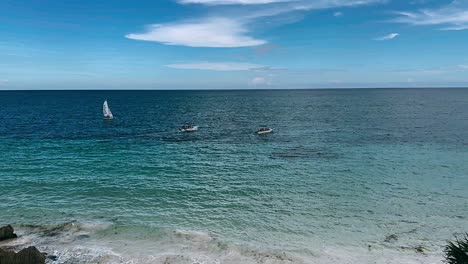 beautiful beach scene with boats and sailboat