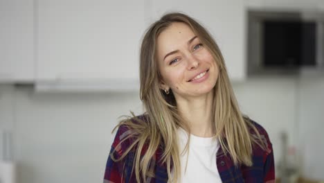 Portrait-of-attractive-blond-woman-at-white-kitchen