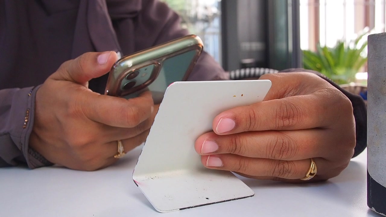 Close-up of Hands Holding Smartphone and Credit Card for Online Payment