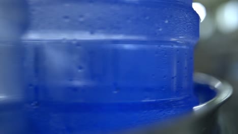 a close-up view of water containers in a production line