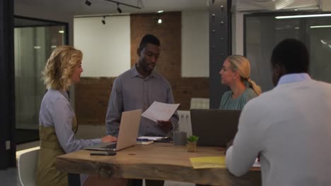 Diverse-group-of-business-colleagues-talking-in-a-meeting-room