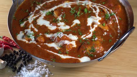 rotating shot of a fresh malaysian curry in a balti dish ready to be served