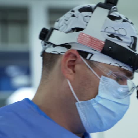 portrait of a male surgeon in medical mask. doctor's face in surgical flashlight in the hospital. health and wellness in private clinic
