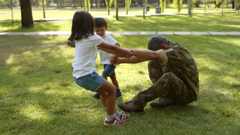 happy military dad playing and having fun with his kids