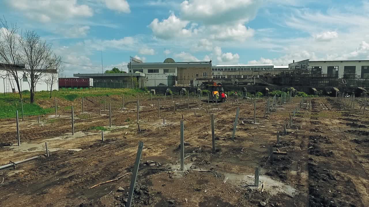 Construction site shot from above. Aerial view of excavator working on construction site