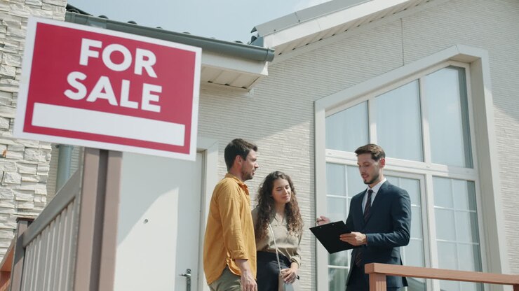 Real Estate Agent Discussing House with Potential Buyers