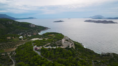 high angle view of kritinia castle ruins atop hill on rhodes coastline - panoramic view over aegean sea and islets
