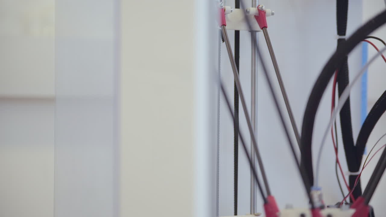 Close-up of the mechanical components of a 3D printer or similar machine