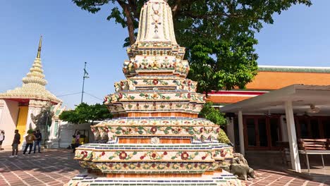 tourists admire pagoda at wat pho temple