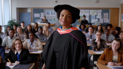 professor in academic regalia addressing a diverse group of students in a classroom