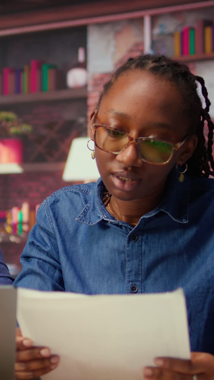 Professional African American Woman Reading Document in Office