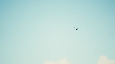 slow motion shot of a helicopter flying in the sky making a right hand turn