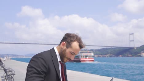 Businessman-against-Istanbul-Bosphorus-bridge-and-ships.