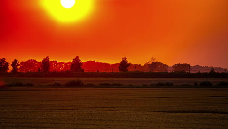 combine harvester gathering crops during a brilliant sunset - time lapse