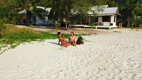 two women relaxing on a tropical beach
