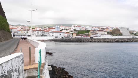 people walking by the bay promenade angra do heroismo in terceira island, azores portugal