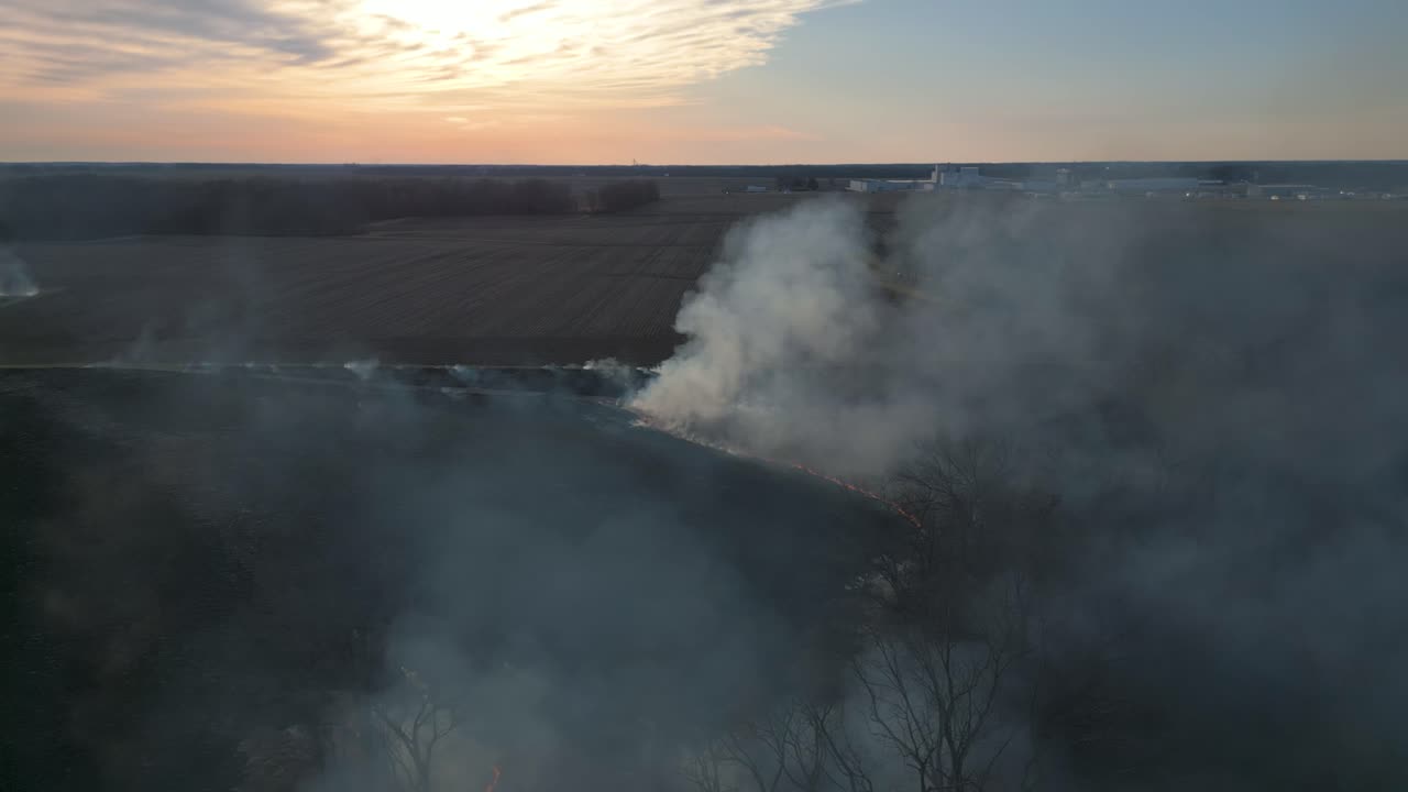 A prairie burn taking place at sunset in central Illinois. The smoke can be seen for miles as it rises into the dusk sky