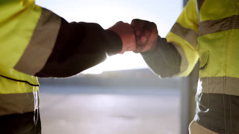 construction workers fist bumping