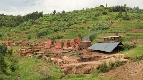 wide shot of brick making operation in rural rwanda