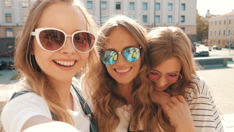 three friends taking a selfie in the city