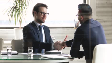 smiling mixed race businessmen celebrating partnership establishment.