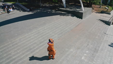 person in inflatable t-rex costume in a park